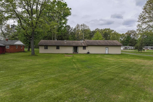 12310 Seymour Rd, Montrose, MI 48457 - rear view of property with a yard and view of wooded area