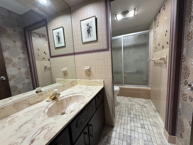 3 Colony Ln, Dearborn, MI 48120 - bathroom featuring tile walls, wallpapered walls, toilet, vanity, and wainscoting
