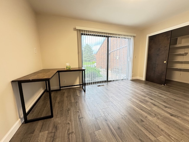 3 Colony Ln, Dearborn, MI 48120 - unfurnished bedroom featuring dark wood-type flooring, baseboards, and a closet