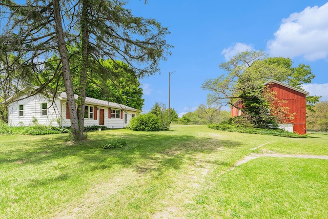 10827 N 12th St, Plainwell, MI 49080 - view of green lawn featuring an outdoor structure
