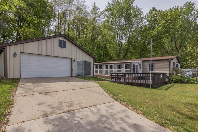 10303 Walnut Dr, Three Rivers, MI 49093 - view of front of house featuring a front yard, a detached garage, and a wooden deck
