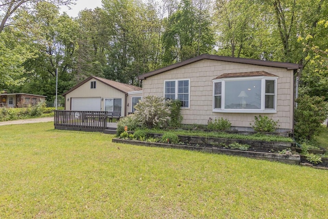 10303 Walnut Dr, Three Rivers, MI 49093 - view of front of house with an outdoor structure, a detached garage, a front yard, and view of wooded area