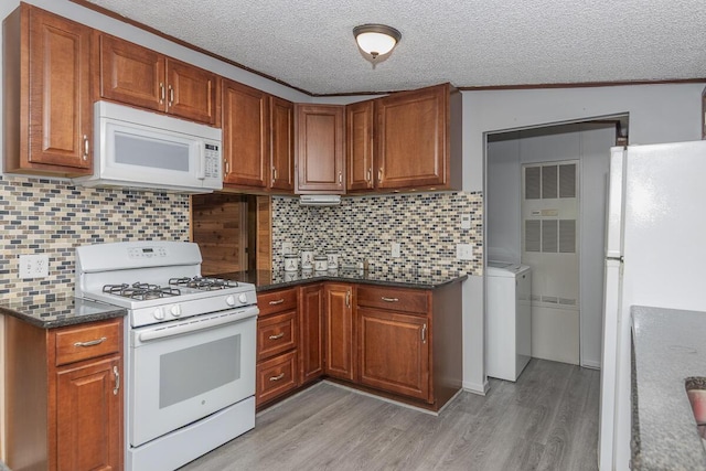 10303 Walnut Dr, Three Rivers, MI 49093 - kitchen with white appliances, washer / clothes dryer, light wood-type flooring, a textured ceiling, and brown cabinetry