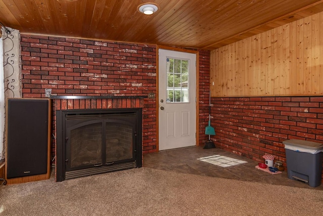 10303 Walnut Dr, Three Rivers, MI 49093 - unfurnished living room featuring a brick fireplace, wood ceiling, carpet flooring, brick wall, and wooden walls