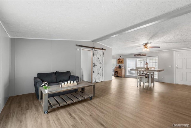 351 N Squirrel Rd, Auburn Hills, MI 48326 - living area with a barn door, a textured ceiling, light wood-type flooring, ceiling fan, and ornamental molding