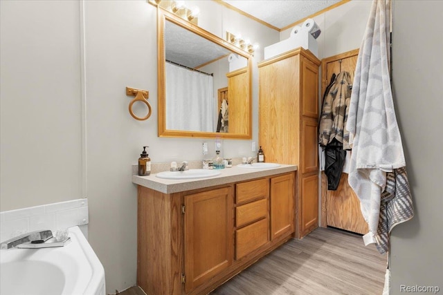 351 N Squirrel Rd, Auburn Hills, MI 48326 - bathroom with double vanity, wood finished floors, a bath, crown molding, and a shower with shower curtain