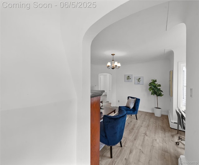 31777 Hennepin St, Garden City, MI 48135 - hallway featuring arched walkways, wood finished floors, a chandelier, baseboard heating, and baseboards