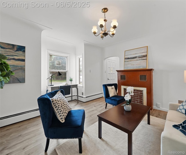 31777 Hennepin St, Garden City, MI 48135 - living area featuring arched walkways, a chandelier, light wood finished floors, and a baseboard radiator