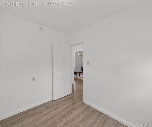 31777 Hennepin St, Garden City, MI 48135 - unfurnished room with baseboards, wood finished floors, and arched walkways