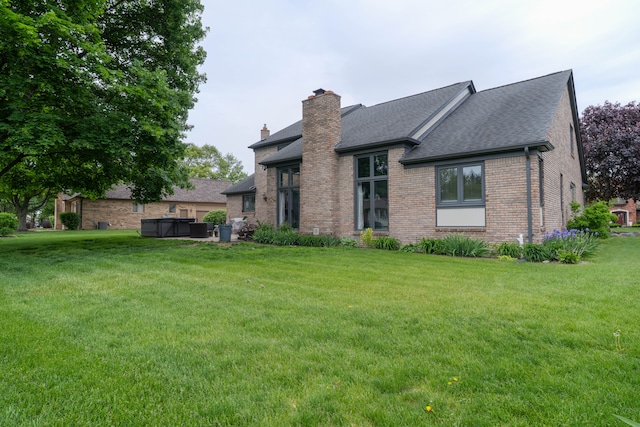 14607 Stratford, Shelby Twp, MI 48315 - rear view of property with brick siding, a yard, roof with shingles, and a chimney