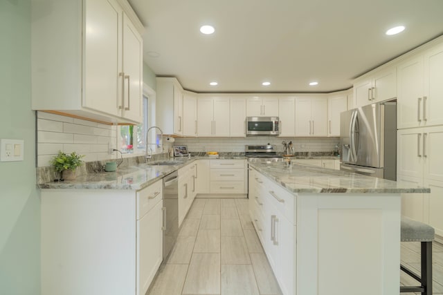 14607 Stratford, Shelby Twp, MI 48315 - kitchen with stainless steel appliances, a sink, a kitchen island, decorative backsplash, and recessed lighting