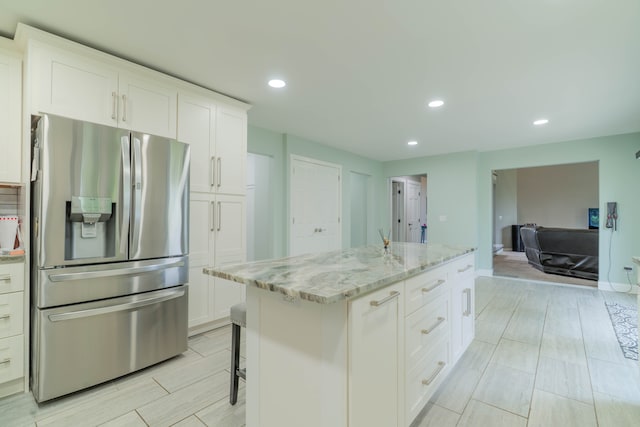 14607 Stratford, Shelby Twp, MI 48315 - kitchen featuring stainless steel fridge, light stone countertops, a center island, white cabinetry, and recessed lighting