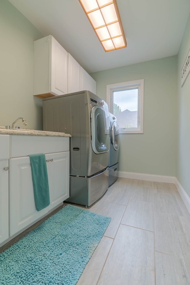 14607 Stratford, Shelby Twp, MI 48315 - laundry area featuring cabinet space, washing machine and clothes dryer, and baseboards