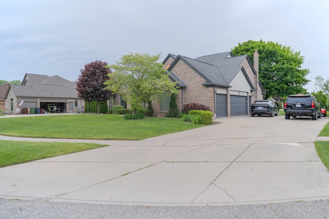 14607 Stratford, Shelby Twp, MI 48315 - view of front facade with a front lawn, an attached garage, brick siding, a chimney, and concrete driveway