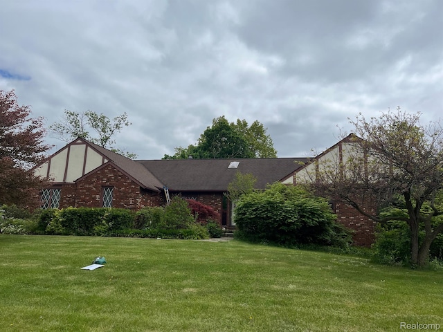 2149 Russet Dr, Troy, MI 48098 - tudor-style house featuring a front yard and brick siding