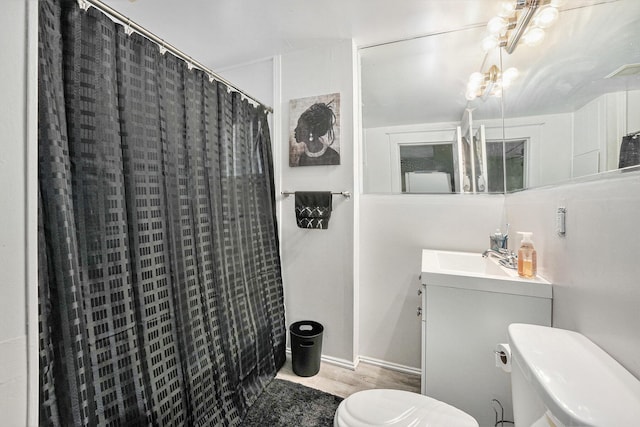 1107 11th St NW, Grand Rapids, MI 49504 - full bath with toilet, a shower with shower curtain, vanity, and wood finished floors