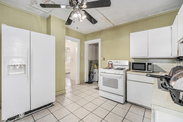 1107 11th St NW, Grand Rapids, MI 49504 - kitchen with white appliances, light tile patterned floors, light countertops, ceiling fan, and white cabinetry