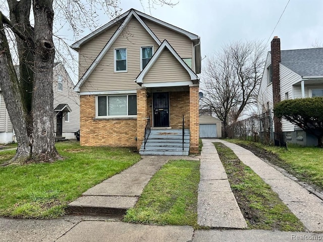9966 Hartwell St, Detroit, MI 48227 - view of front facade featuring brick siding, a front lawn, and an outbuilding