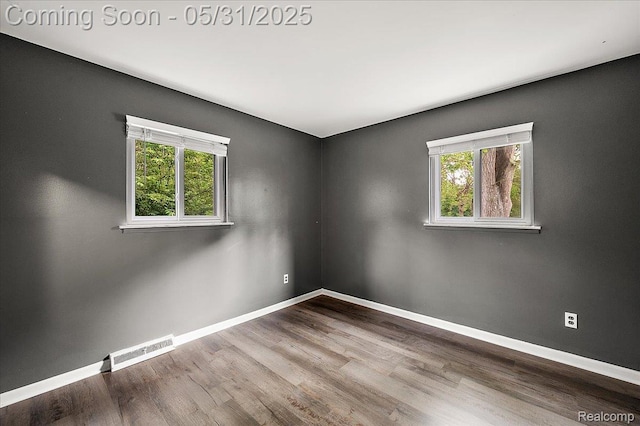 2920 Pinto Dr, Commerce Twp, MI 48382 - empty room featuring plenty of natural light, baseboards, and wood finished floors