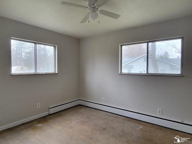 8255 Secor Rd, Lambertville, MI 48144 - unfurnished room featuring ceiling fan, a baseboard heating unit, wood finished floors, and baseboards