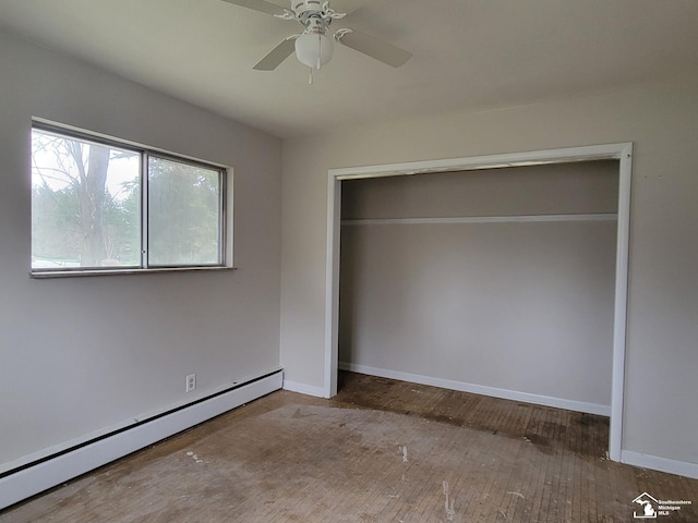 8255 Secor Rd, Lambertville, MI 48144 - unfurnished bedroom with baseboard heating, baseboards, hardwood / wood-style floors, and a closet