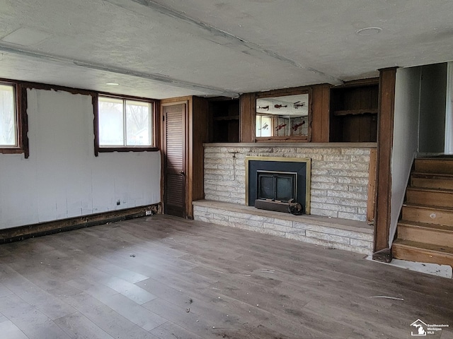 8255 Secor Rd, Lambertville, MI 48144 - unfurnished living room with a fireplace, wood finished floors, stairs, and plenty of natural light