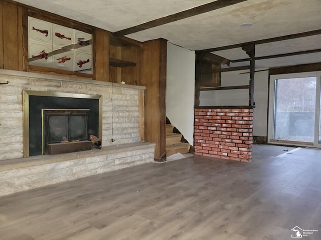 8255 Secor Rd, Lambertville, MI 48144 - unfurnished living room with wood finished floors, stairway, a brick fireplace, and beamed ceiling
