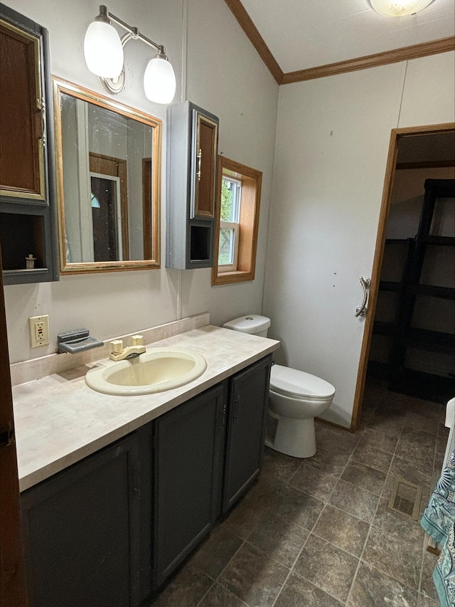 815 Hyatt St, Eaton Rapids, MI 48827 - bathroom featuring crown molding, stone finish floors, vanity, toilet, and a shower