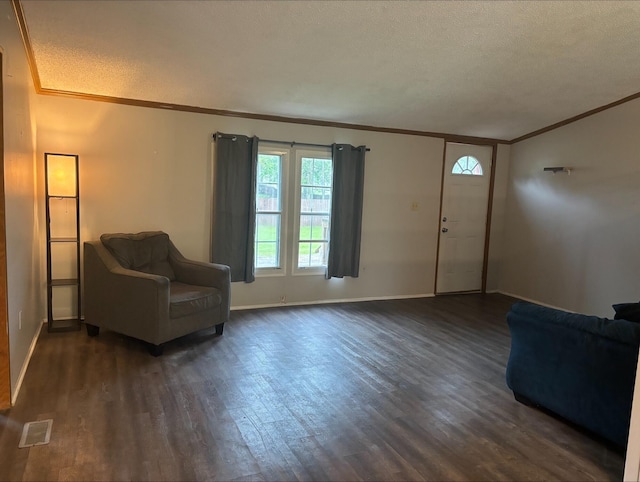 815 Hyatt St, Eaton Rapids, MI 48827 - entryway with crown molding, dark wood finished floors, baseboards, and a textured ceiling