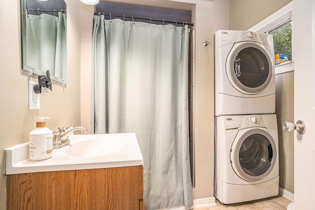 201 Page St NE, Grand Rapids, MI 49505 - washroom featuring stacked washing machine and dryer and baseboards
