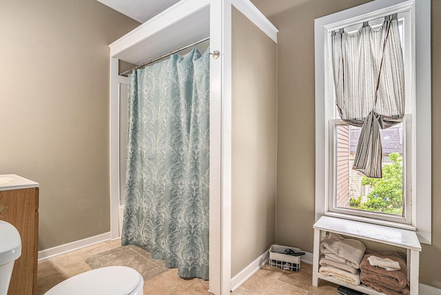 201 Page St NE, Grand Rapids, MI 49505 - full bathroom with toilet, vanity, baseboards, and tile patterned floors