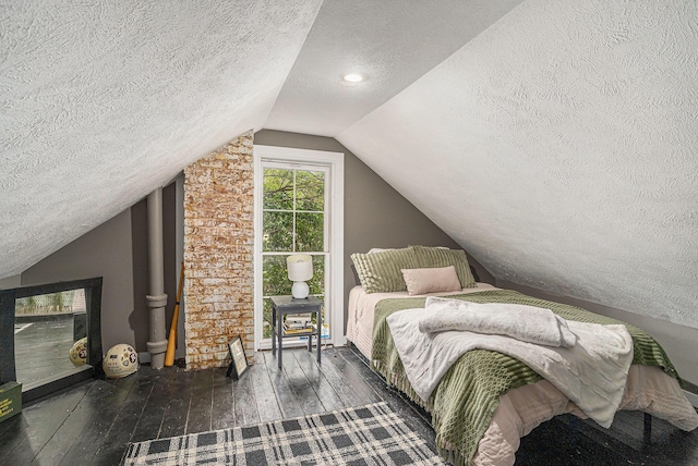 201 Page St NE, Grand Rapids, MI 49505 - bedroom with a textured ceiling, lofted ceiling, and hardwood / wood-style flooring