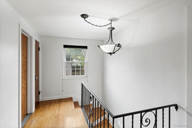 99 Wenonah Dr, Pontiac, MI 48341 - corridor with an upstairs landing, light wood-style floors, and baseboards