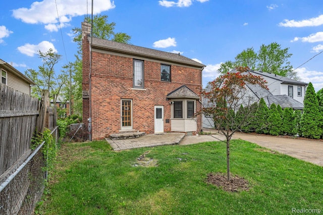 99 Wenonah Dr, Pontiac, MI 48341 - rear view of house featuring brick siding, a patio, and a chimney