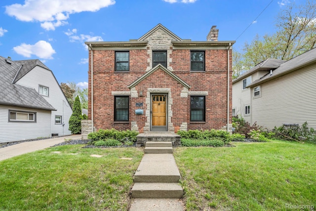 99 Wenonah Dr, Pontiac, MI 48341 - traditional home featuring brick siding, a front lawn, and a chimney