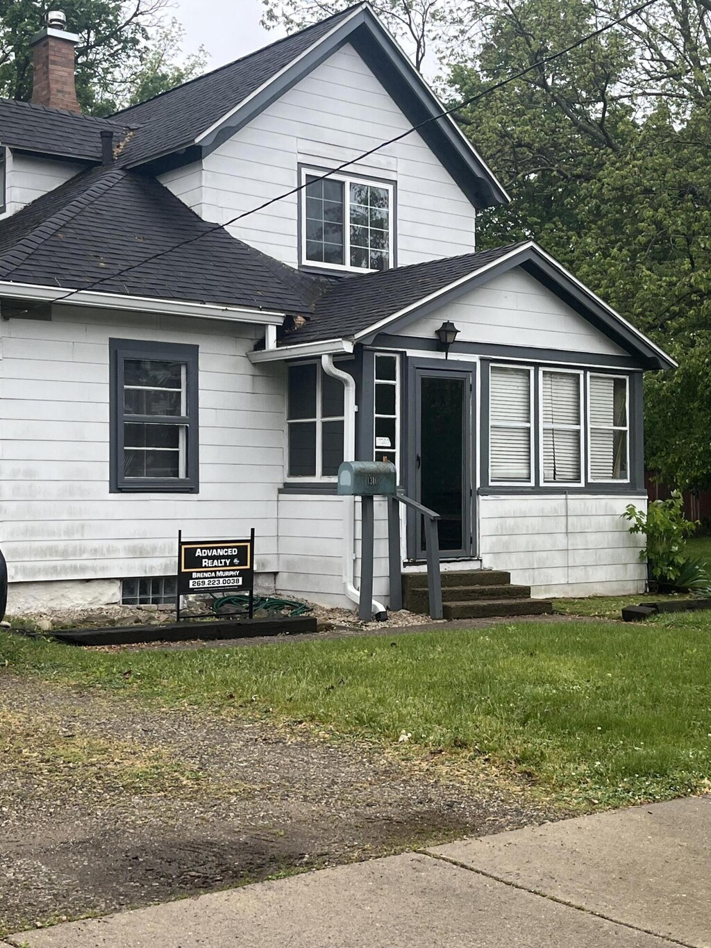 1310 Lake St, Kalamazoo, MI 49001 - view of front of property with roof with shingles, a chimney, and entry steps
