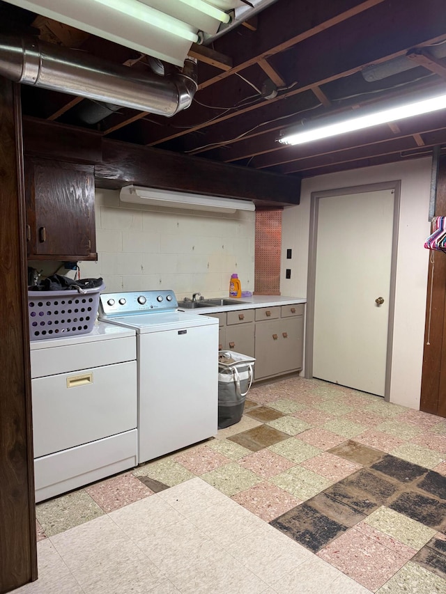 3104 Chippewa Hwy, Manistee, MI 49660 - laundry area with light floors, cabinet space, washer and dryer, and concrete block wall
