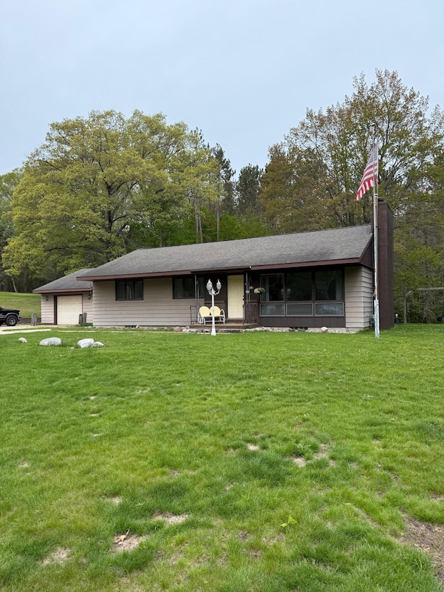 3104 Chippewa Hwy, Manistee, MI 49660 - back of house with a yard and a detached garage