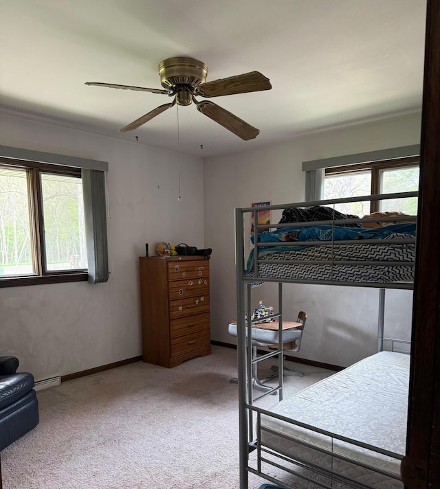 3104 Chippewa Hwy, Manistee, MI 49660 - bedroom with carpet floors, ceiling fan, baseboards, and a baseboard heating unit