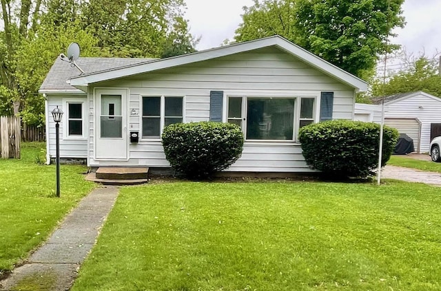 612 N Prospect St, Sturgis, MI 49091 - bungalow-style house with a detached garage and roof with shingles