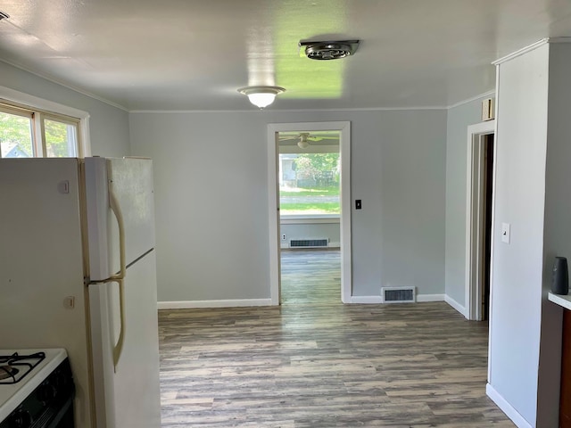 612 N Prospect St, Sturgis, MI 49091 - kitchen featuring wood finished floors, crown molding, baseboards, and white appliances
