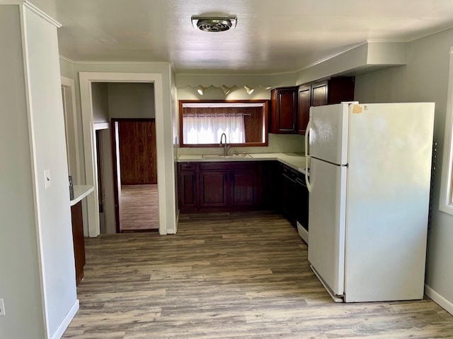 612 N Prospect St, Sturgis, MI 49091 - kitchen featuring freestanding refrigerator, a sink, light countertops, and wood finished floors