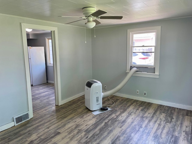 612 N Prospect St, Sturgis, MI 49091 - spare room featuring crown molding, wood finished floors, baseboards, and ceiling fan