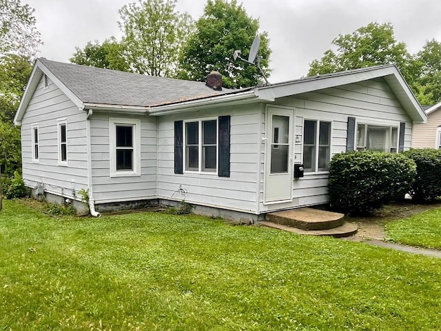 612 N Prospect St, Sturgis, MI 49091 - view of front facade with a chimney and a front lawn