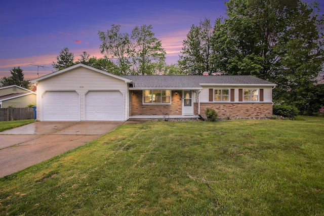 1246 Chalmers Dr, Battle Creek, MI 49015 - split level home featuring brick siding, an attached garage, driveway, and a chimney