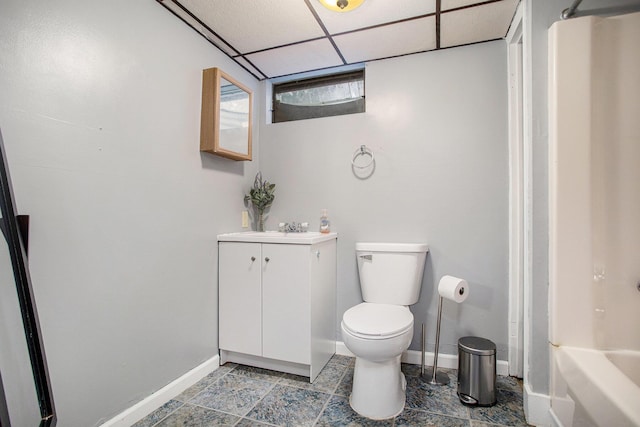 1246 Chalmers Dr, Battle Creek, MI 49015 - bathroom with toilet, baseboards, vanity, and a drop ceiling