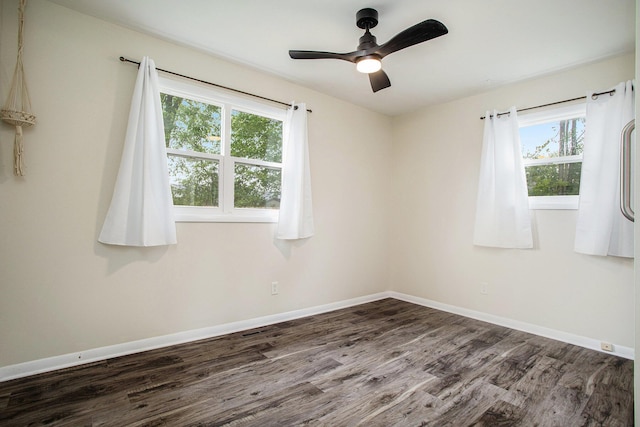 1246 Chalmers Dr, Battle Creek, MI 49015 - spare room with dark wood finished floors, baseboards, and a ceiling fan