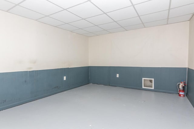 455 N Centre St, Schoolcraft, MI 49087 - empty room with a paneled ceiling, finished concrete floors, and wainscoting