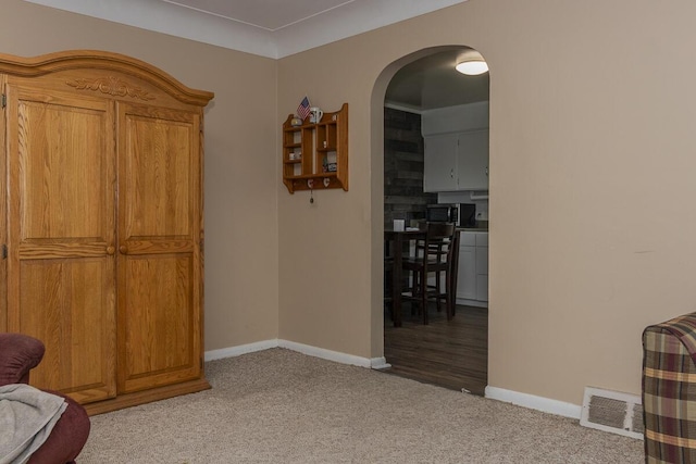 455 N Centre St, Schoolcraft, MI 49087 - living area featuring baseboards, light colored carpet, and arched walkways