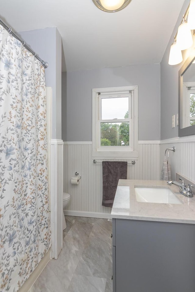 455 N Centre St, Schoolcraft, MI 49087 - bathroom featuring a wainscoted wall, toilet, vanity, marble finish floors, and a shower with curtain